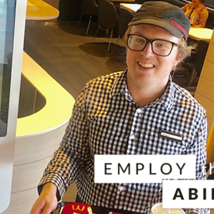 Christopher Croker, Employee at McDonald’s standing at work with a food tray with the words "employe their ability" stamped on the image. 